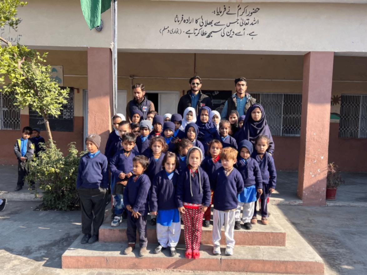 Children receiving books and uniforms